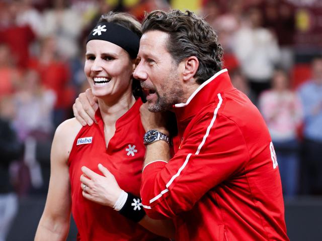 Belgium's Greet Minnen (L) celebrates alongside team's coach Wim Fissette after winning her match against USA's Iva Jovic during the Billie Jean King Cup tennis play-offs in Ostend on April 11, 2026. (Photo by BENOIT DOPPAGNE / Belga / AFP) / Belgium OUT