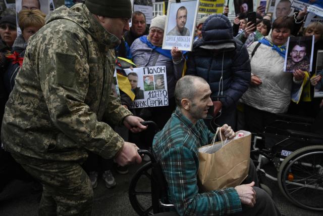 A released Ukrainian prisoner of war (POW) is pushed in a wheelchair after being swapped in a prisoner exchange in the Chernihiv region on April 11, 2026, amid the Russian invasion of Ukraine. A truce between Russia and Ukraine to mark the Orthodox Easter entered into force on April 11, 2026, with Kyiv warning it would respond "immediately" if Russia violated it. The warring sides exchanged 175 prisoners of war each, both countries said, in one of their few areas of cooperation. (Photo by Genya SAVILOV / AFP)