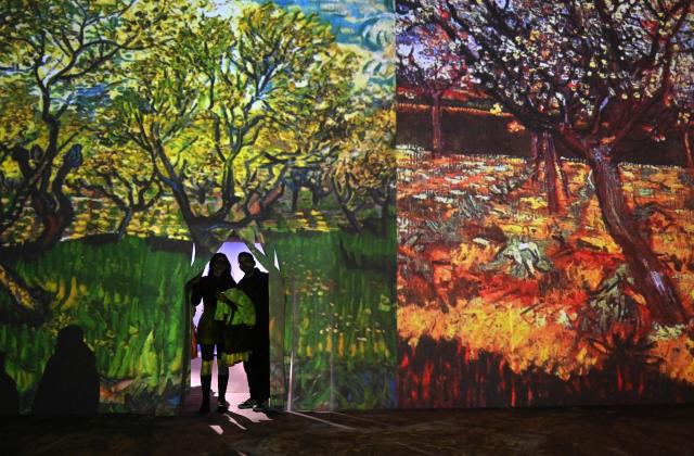 People visit the immersive exhibition "Van Gogh's Universe. From Madness to Genius" in Kyiv on April 11, 2026, amid the Russian invasion of Ukraine. (Photo by Sergei SUPINSKY / AFP)