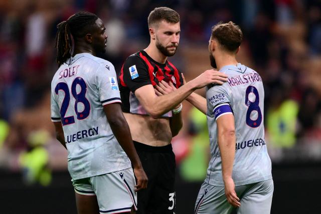 AC Milan's Serbian defender #31 Strahinja Pavlovic (C) embraces Udinese's Swedish midfielder #08 Jesper Karlstrom (R) at the end of the Italian Serie A football match between AC Milan and Udinese at the San Siro Stadium in Milan, northern Italy, on April 11, 2026. (Photo by MARCO BERTORELLO / AFP)