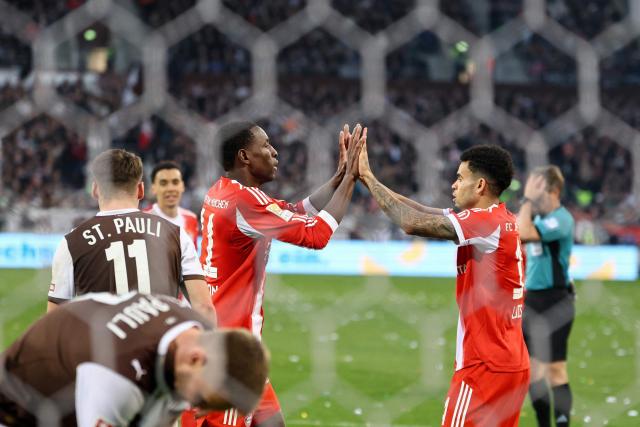 Bayern Munich's Senegalese forward #11 Nicolas Jackson celebrates scoring the 0-4 goal with his teammate Bayern Munich's Colombian forward #14 Luis Diaz (R) during the German first division Bundesliga football match between FC St Pauli and FC Bayern Munich in Hamburg, northern Germany, on April 11, 2026. (Photo by Ibo OT / AFP) / DFL REGULATIONS PROHIBIT ANY USE OF PHOTOGRAPHS AS IMAGE SEQUENCES AND/OR QUASI-VIDEO