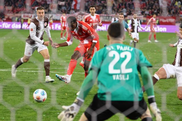 Bayern Munich's Senegalese forward #11 Nicolas Jackson (C) scores the 0-4 goal past St Pauli's Bosnian goalkeeper #22 Nikola Vasilj during the German first division Bundesliga football match between FC St Pauli and FC Bayern Munich in Hamburg, northern Germany, on April 11, 2026. (Photo by Ibo OT / AFP) / DFL REGULATIONS PROHIBIT ANY USE OF PHOTOGRAPHS AS IMAGE SEQUENCES AND/OR QUASI-VIDEO