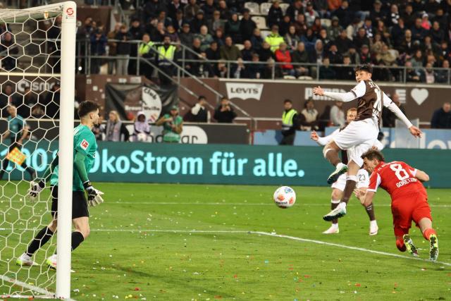 Bayern Munich's German midfielder #08 Leon Goretzka (R) scores the 0-6 goal during the German first division Bundesliga football match between FC St Pauli and FC Bayern Munich in Hamburg, northern Germany, on April 11, 2026. (Photo by Ibo OT / AFP) / DFL REGULATIONS PROHIBIT ANY USE OF PHOTOGRAPHS AS IMAGE SEQUENCES AND/OR QUASI-VIDEO