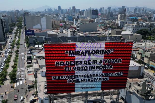 Aerial view of a billboard reading "Be sure to go and vote. Your vote counts" in Miraflores, Lima on April 11, 2026, on the eve of presidential elections. Peru, which has had eight presidents in ten years, will hold general election on April 12, 2026, in which voters will have to choose among 35 candidates. (Photo by Luis ROBAYO / AFP)