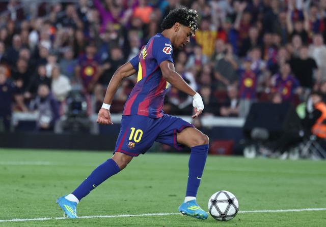 Barcelona's Spanish forward #10 Lamine Yamal scores his team's third goal during the Spanish league football match between FC Barcelona and RCD Espanyol at the Camp Nou stadium in Barcelona on April 11 , 2026. (Photo by Josep LAGO / AFP)
