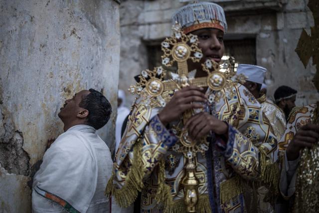 Followers of the Ethiopian Orthodox Church celebrate the Holy Fire ceremony in Jerusalem’s Church of the Holy Sepulchre, on April 11, 2026, on the eve of Easter Sunday. The ceremony celebrated in the same way for 11 centuries, is marked by the appearance of "sacred fire" in the two cavities on either side of the Holy Sepulchre. (Photo by MARCO LONGARI / AFP)