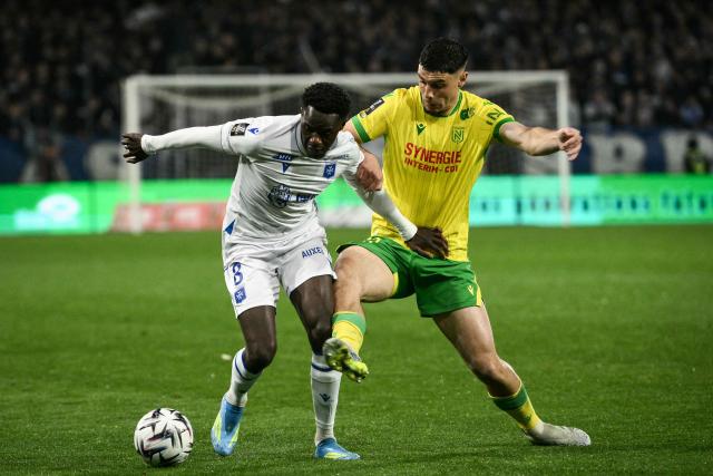 Auxerre’s French midfielder #08 Naouirou Ahamada (L) fights for the ball with Nantes’ French midfielder #20 Rйmy Cabella (R) during the French L1 football match between AJ Auxerre and FC Nantes at the Stade de l'Abbe-Deschamps in Auxerre, central France, on April 11, 2026. (Photo by ARNAUD FINISTRE / AFP)