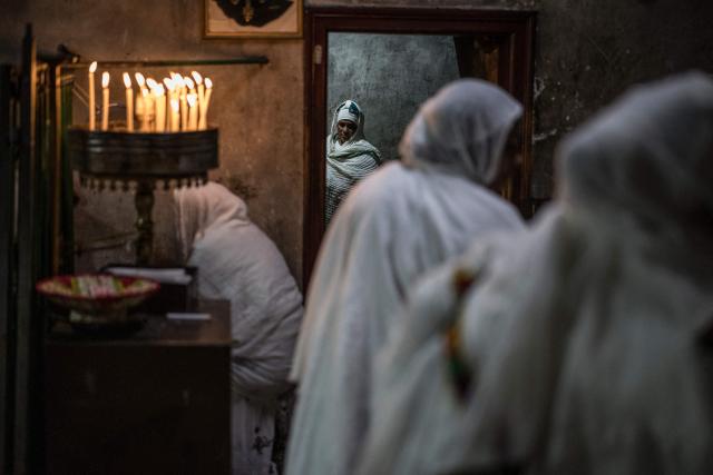 Followers of the Ethiopian Orthodox Church pray during the Holy Fire ceremony in Jerusalem’s Church of the Holy Sepulchre, on April 11, 2026, on the eve of Easter Sunday. The ceremony celebrated in the same way for 11 centuries, is marked by the appearance of "sacred fire" in the two cavities on either side of the Holy Sepulchre. (Photo by MARCO LONGARI / AFP)