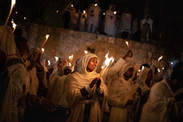 Ethiopian Orthodox Christian followers hold up candles during their annual Holy Fire ceremony at Jerusalem’s Church of the Holy Sepulchre on April 11, 2026. The ceremony celebrated in the same way for 11 centuries, is marked by the appearance of "sacred fire" in the two cavities on either side of the Holy Sepulchre. (Photo by JOHN WESSELS / AFP)