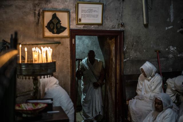 Followers of the Ethiopian Orthodox Church pray during the Holy Fire ceremony in Jerusalem’s Church of the Holy Sepulchre, on April 11, 2026. The ceremony celebrated in the same way for 11 centuries, is marked by the appearance of "sacred fire" in the two cavities on either side of the Holy Sepulchre. (Photo by MARCO LONGARI / AFP)