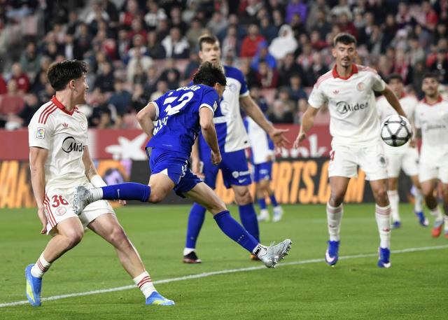Atletico Madrid's Spanish defender #32 Javier Bonar scores his team's first goal during the Spanish league football match between Sevilla FC and Club Atletico de Madrid at the Ramon Sanchez Pizjuan stadium in Seville on April 11 , 2026. (Photo by CRISTINA QUICLER / AFP)
