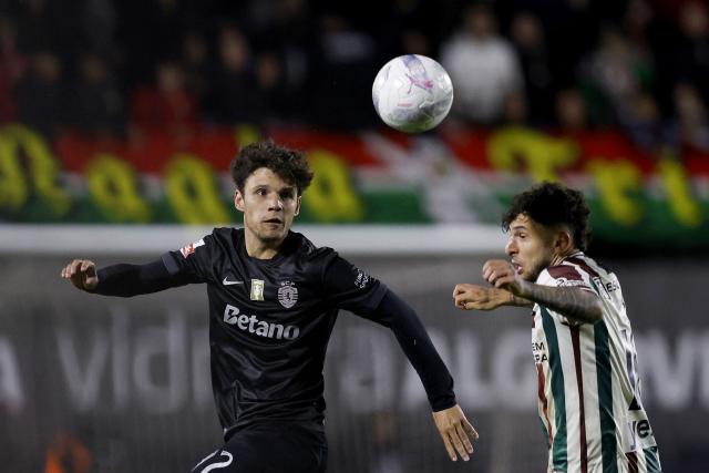 Sporting Lisbon's Portuguese defender #72 Eduardo Quaresma fights for the ball with Estrela da Amadora's Romanian forward #10 Ianis Stoica the Portuguese League football match between CF Estrela da Amadora and Sporting CP at Jose Gomes stadium in Amadora  on April 11 , 2026. (Photo by FILIPE AMORIM / AFP)