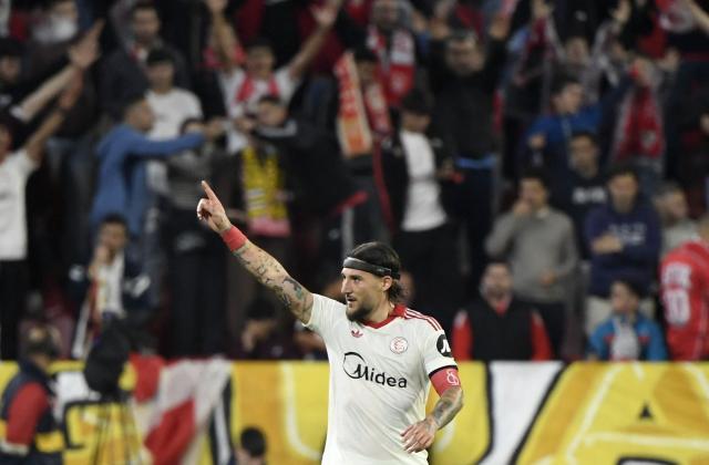 Sevilla's Serbian midfielder #06 Nemanja Gudelj celebrates scoring his team's second goal during the Spanish league football match between Sevilla FC and Club Atletico de Madrid at the Ramon Sanchez Pizjuan stadium in Seville on April 11 , 2026. (Photo by CRISTINA QUICLER / AFP)