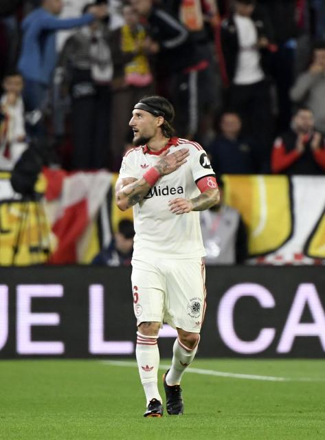 Sevilla's Serbian midfielder #06 Nemanja Gudelj celebrates scoring his team's second goal during the Spanish league football match between Sevilla FC and Club Atletico de Madrid at the Ramon Sanchez Pizjuan stadium in Seville on April 11 , 2026. (Photo by CRISTINA QUICLER / AFP)