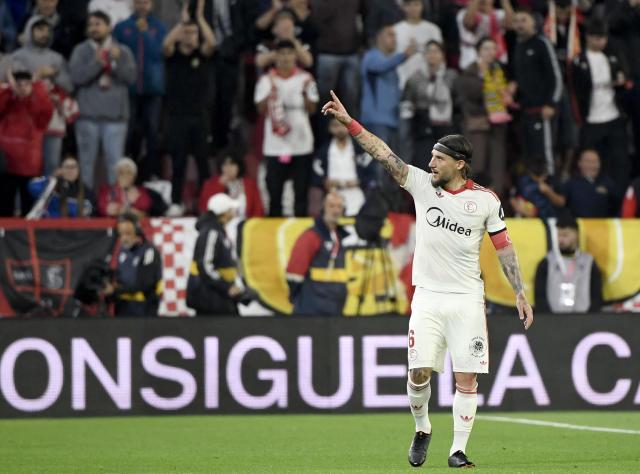 Sevilla's Serbian midfielder #06 Nemanja Gudelj celebrates scoring his team's second goal during the Spanish league football match between Sevilla FC and Club Atletico de Madrid at the Ramon Sanchez Pizjuan stadium in Seville on April 11 , 2026. (Photo by CRISTINA QUICLER / AFP)