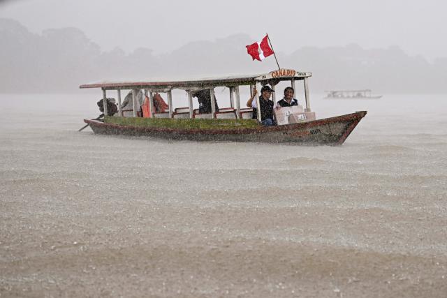 Workers of the National Office of Electoral Processes (ONPE) transport electoral material from the port of Pucallpa to hard-to-reach communities, travelling along the Ucayali River, in the department of Ucayali, in the central-eastern jungle of Peru, on April 11, 2026. Peru, which has had eight presidents in ten years, will hold general election on April 12, 2026, in which voters will have to choose among 35 candidates. (Photo by Hugo Alejos / AFP)