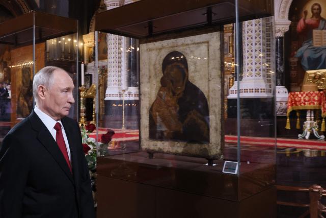 In this pool photograph distributed by the Russian state agency Sputnik, Russia's President Vladimir Putin attends the Orthodox Easter service at the Cathedral of Christ the Saviour in Moscow on April 12, 2026. (Photo by Mikhail METZEL / POOL / AFP)