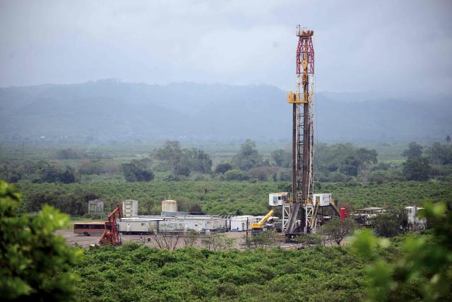 View of a Pemex well and machinery installed amidst lemon crops in the Puente Remolino area, in Papantla, state of Veracruz on April 11, 2026. The Mexican government plans to extract natural gas using hydraulic fracturing, a method that has been criticized by environmental organizations, in order to reduce its dependence on imports from the United States, according to a plan presented by President Claudia Sheinbaum on April 9, 2026. (Photo by Marco Antonio MARTINEZ / AFP)
