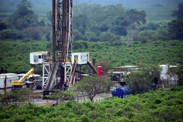 View of a Pemex well and machinery installed amidst lemon crops in the Puente Remolino area, in Papantla, state of Veracruz on April 11, 2026. The Mexican government plans to extract natural gas using hydraulic fracturing, a method that has been criticized by environmental organizations, in order to reduce its dependence on imports from the United States, according to a plan presented by President Claudia Sheinbaum on April 9, 2026. (Photo by Marco Antonio MARTINEZ / AFP)