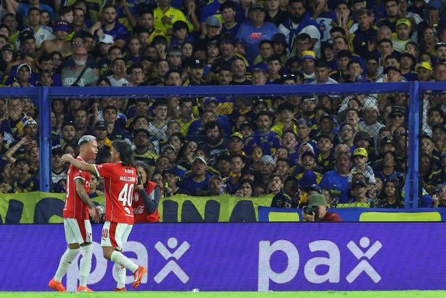 Independiente's Uruguayan forward #19 Matias Abaldo celebrates after scoring the opening goal with teammate Independiente's midfielder #40 Victor Malcorra during the Argentine Professional Football League 2026 Apertura Tournament match between Boca Juniors and Independiente at La Bombonera Stadium in Buenos Aires on April 11, 2026. (Photo by Alejandro PAGNI / AFP)