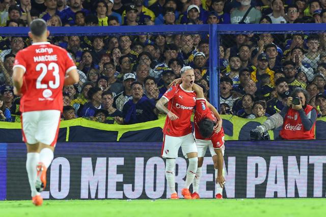 Independiente's Uruguayan forward #19 Matias Abaldo celebrates after scoring the opening goal with teammate midfielder #40 Victor Malcorra during the Argentine Professional Football League 2026 Apertura Tournament match between Boca Juniors and Independiente at La Bombonera Stadium in Buenos Aires on April 11, 2026. (Photo by Alejandro PAGNI / AFP)