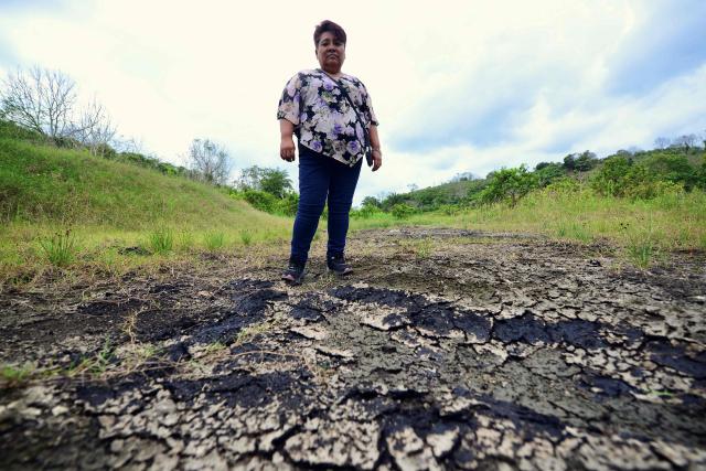 Gloria Dominguez Castillo stands in her fields, contaminated by fracking, in the community of Rafael Rosas, in Papantla, state of Veracruz on April 11, 2026. The Mexican government plans to extract natural gas using hydraulic fracturing, a method that has been criticized by environmental organizations, in order to reduce its dependence on imports from the United States, according to a plan presented by President Claudia Sheinbaum on April 9, 2026. (Photo by Marco Antonio MARTINEZ / AFP)