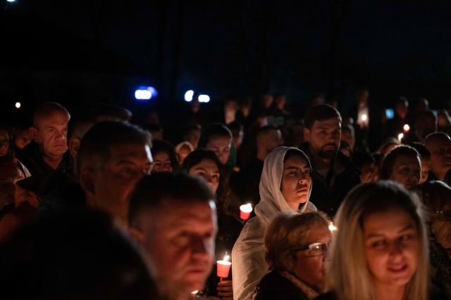 Orthodox believers hold candles as they take part in midnight Easter Service at the Gracanica medieval monastery near Pristina, Kosovo, on April 12, 2026. (Photo by Armend NIMANI / AFP)