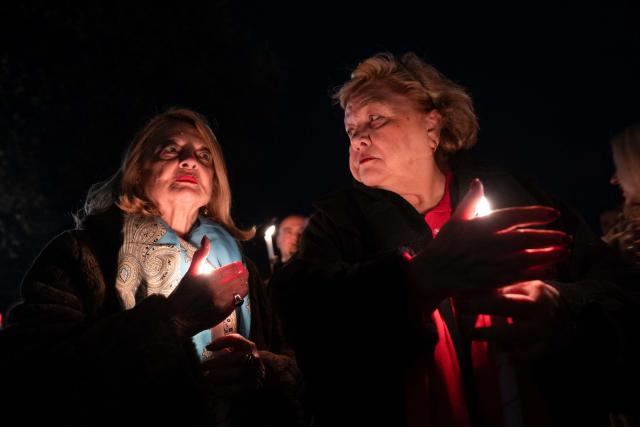 Orthodox believers hold candles as they takes part in midnight Easter Service at the Gracanica medieval monastery near Pristina, Kosovo, on April 12, 2026. (Photo by Armend NIMANI / AFP)