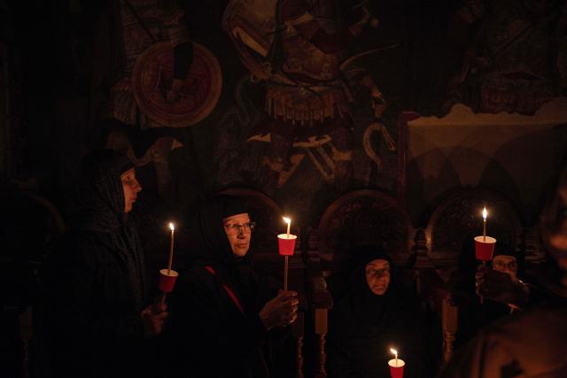 Orthodox nuns hold candles as they take part in midnight Easter Service at the Gracanica medieval monastery near Pristina, Kosovo, on April 12, 2026. (Photo by Armend NIMANI / AFP)