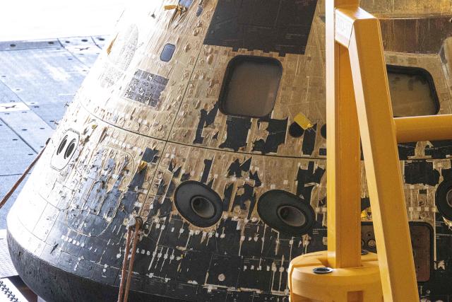 The NASA ORION capsule named “Integrity” showing scarring burns from the heat of re-entry arrives in to the Port of San Diego in San Diego, California, on April 11, 2026. An elated NASA late April 10 was celebrating its successful voyage around the Moon, after four astronauts safely returned to Earth having completed the first lunar flyby in more than 50 years. The NASA spacecraft carrying four astronauts -- three Americans and one Canadian -- splashed down without a hitch off the California coast, capping the US space agency's crewed test mission that returned with spectacular images of the Moon. (Photo by Matt HARTMAN / AFP)