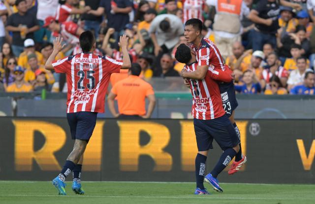 Tigres' Brazilian midfielder #23 Romulo Zwarg celebrates after scoring with teammates Uruguayan midfielder #05 Cesar Araujo and goalkeeper #25 Carlos Rodriguez  during the Liga MX Clausura tournament football match between Tigres and Guadalajara at the Universitario stadium in San Nicolas de los Garza, state of Nuevo Leon, Mexico, on April 11, 2026. (Photo by Julio Cesar AGUILAR / AFP)