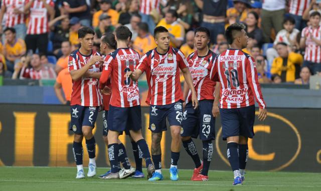 Tigres' Brazilian midfielder #23 Romulo Zwarg celebrates after scoring with teammates during the Liga MX Clausura tournament football match between Tigres and Guadalajara at the Universitario stadium in San Nicolas de los Garza, state of Nuevo Leon, Mexico, on April 11, 2026. (Photo by Julio Cesar AGUILAR / AFP)
