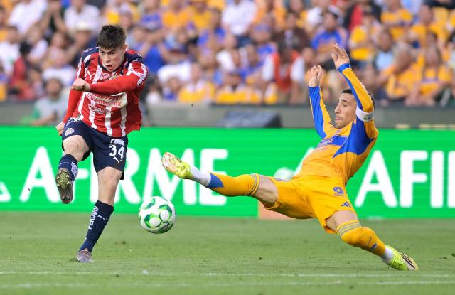 Guadalajara's forward #34 Armando Gonzalez and Tigres' Uruguayan midfielder #08 Fernando Gorriaran fight for the ball during the Liga MX Clausura tournament football match between Tigres and Guadalajara at the Universitario stadium in San Nicolas de los Garza, state of Nuevo Leon, Mexico, on April 11, 2026. (Photo by AFP)