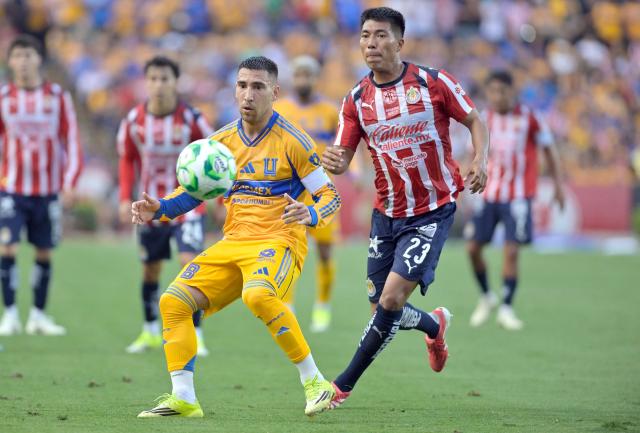 Tigres' Uruguayan midfielder #08 Fernando Gorriaran and Guadalajara's US midfielder #23 Daniel Aguirre fight for the ball during the Liga MX Clausura tournament football match between Tigres and Guadalajara at the Universitario stadium in San Nicolas de los Garza, state of Nuevo Leon, Mexico, on April 11, 2026. (Photo by AFP)
