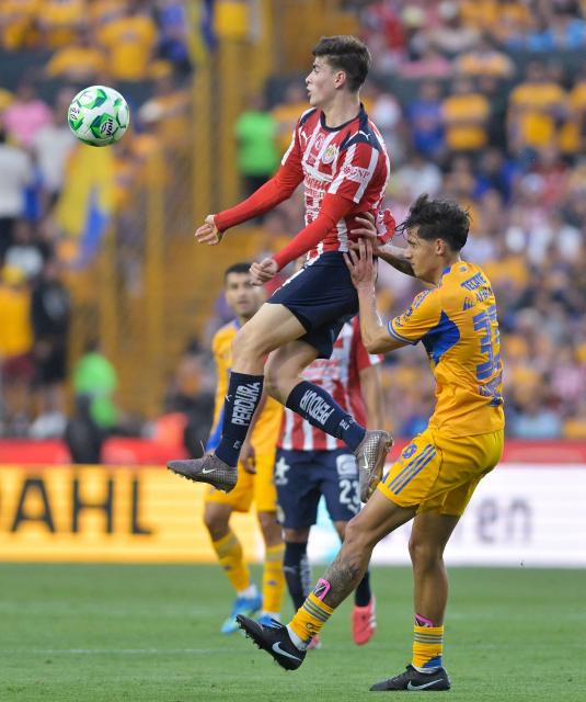 Guadalajara's forward #34 Armando Gonzalez and Tigres' defender #33 Rafael Guerrero fight for the ball during the Liga MX Clausura tournament football match between Tigres and Guadalajara at the Universitario stadium in San Nicolas de los Garza, state of Nuevo Leon, Mexico, on April 11, 2026. (Photo by AFP)