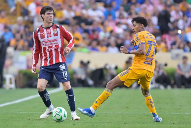 Guadalajara's defender #19 Diego Campillo and Tigres' forward #77 Ozziel Herrera fight for the ball during the Liga MX Clausura tournament football match between Tigres and Guadalajara at the Universitario stadium in San Nicolas de los Garza, state of Nuevo Leon, Mexico, on April 11, 2026. (Photo by AFP)