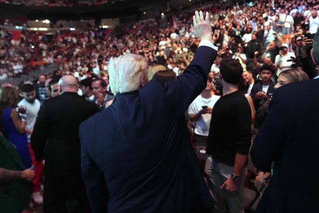 US President Donald Trump waves to the crowd at UFC 327: Jiri Prochazka vs Carlos Ulberg at Kaseya Center in Miami, on April 11, 2026. (Photo by Julia Demaree Nikhinson / POOL / AFP)