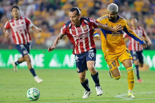 Guadalajara's midfielder #28 Fernando Gonzalez and Tigres’ Uruguayan forward #17 Rodrigo Aguirre fight for the ball during the Liga MX Clausura tournament football match between Tigres and Guadalajara at the Universitario stadium in San Nicolas de los Garza, state of Nuevo Leon, Mexico, on April 11, 2026. (Photo by AFP)