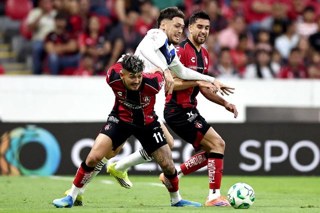 Atlas' Paraguayan forward #11 Diego Gonzalez, Monterrey's Argentine midfielder #29 Lucas Ocampos and Atlas' defender #13 Gaddi Aguirre fight for the ball during the Liga MX Clausura tournament football match between Atlas and Monterrey at the Jalisco stadium in Guadalajara, state of Jalisco, Mexico, on April 11, 2026. (Photo by Ulises Ruiz / AFP)