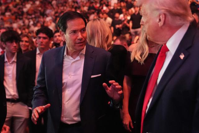 US President Donald Trump speaks with Secretary of State Marco Rubio at UFC 327: Jiri Prochazka vs Carlos Ulberg at Kaseya Center in Miami, on April 11, 2026. (Photo by Julia Demaree Nikhinson / POOL / AFP)
