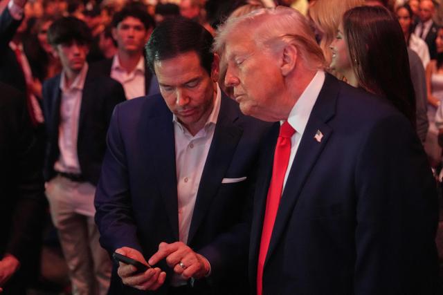 US President Donald Trump speaks with Secretary of State Marco Rubio at UFC 327: Jiri Prochazka vs Carlos Ulberg at Kaseya Center in Miami, on April 11, 2026. (Photo by Julia Demaree Nikhinson / POOL / AFP)