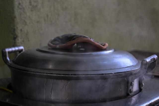 A boiling pot is seen at a curbside canteen in Manila on April 7, 2026. While sticker shock at petrol stations has garnered the biggest headlines since the war in the Middle East forced the partial closure of the Strait of Hormuz, the rising price of LPG has hit the import-dependent archipelago's humble street food vendors hard. (Photo by Jam STA ROSA / AFP) / TO GO WITH AFP STORY: Iran-War-US-Israel-Philippines-economy-LPG, by Pam CASTRO