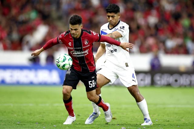 Atlas' forward #58 Arturo Gonzalez and Monterrey's defender #04 Victor Guzman fight for the ball during the Liga MX Clausura tournament football match between Atlas and Monterrey at the Jalisco stadium in Guadalajara, state of Jalisco, Mexico, on April 11, 2026. (Photo by Ulises Ruiz / AFP)