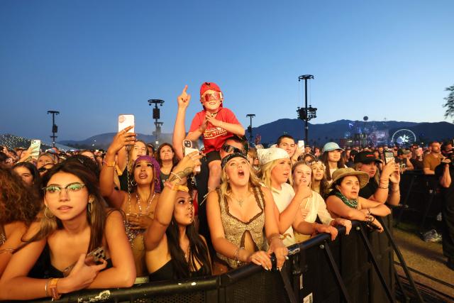Fans cheer while watching US singer songwriter Sombr perform on the Outdoor Theatre stage during the 2026 Coachella Valley Music and Arts Festival in Indio, California on April 11, 2026. (Photo by VALERIE MACON / AFP)