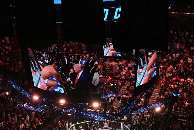 Brazilian Paulo Costa shakes US President Donald Trump's hand after defeating Russian Azamat Murzakanov in a Light Heavyweight bout during UFC 327 at Kaseya Center in Miami, on April 11, 2026. (Photo by Jim WATSON / AFP)