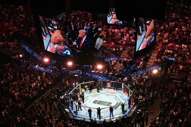 Brazilian Paulo Costa shakes US President Donald Trump's hand after defeating Russian Azamat Murzakanov in a Light Heavyweight bout during UFC 327 at Kaseya Center in Miami, on April 11, 2026. (Photo by Jim WATSON / AFP)
