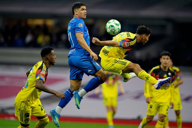 Cruz Azul's Uruguayan forward #21 Gabriel Fernandez and America's Uruguayan defender #04 Sebastian Caceres fight for the ball during the Liga MX Clausura tournament football match between America and Cruz Azul at the Azteca Stadium in Mexico City on April 11, 2026. (Photo by Alfredo ESTRELLA / AFP)