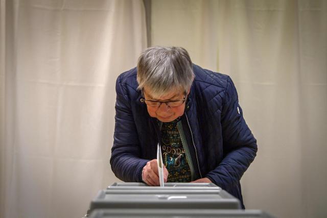 An elderly woman casts her ballot at a polling station in Budapest at the start of a general election in Hungary, on April 12, 2026. The vote could end Hungarian Prime Minister Viktor Orban's 16-year stint in power as the EU's longest serving current leader and a self-decribed "thorn" in the bloc's side. (Photo by Ferenc ISZA / AFP)
