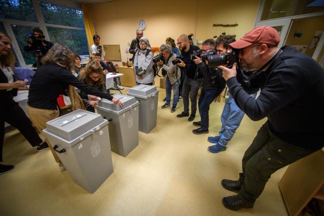 Ballot boxes are sealed in front of the eyes of photographers at a polling station in Budapest at the start of a general election in Hungary, on April 12, 2026. The vote could end Hungarian Prime Minister Viktor Orban's 16-year stint in power as the EU's longest serving current leader and a self-decribed "thorn" in the bloc's side. (Photo by Ferenc ISZA / AFP)