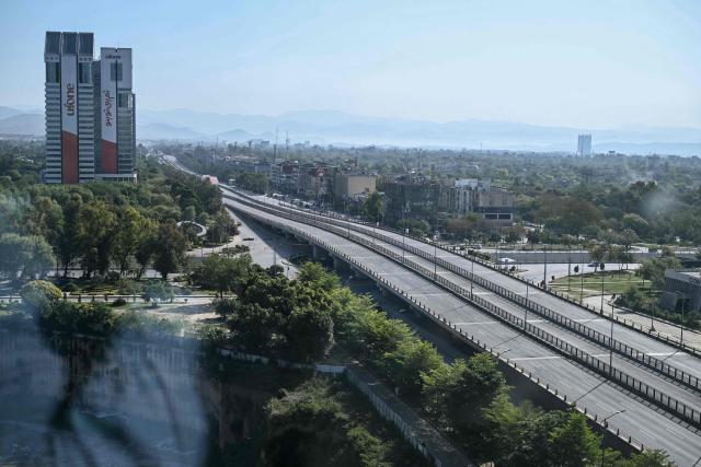 A deserted road is pictured after authorities restricted movement for the US-Iran peace talks in Islamabad on April 12, 2026. Iran and the United States failed to reach an agreement to end the war in the Middle East, US Vice President JD Vance said on April 12 after marathon talks in Islamabad, adding that he was leaving negotiations after giving Tehran the "final and best offer". (Photo by Farooq NAEEM / AFP)